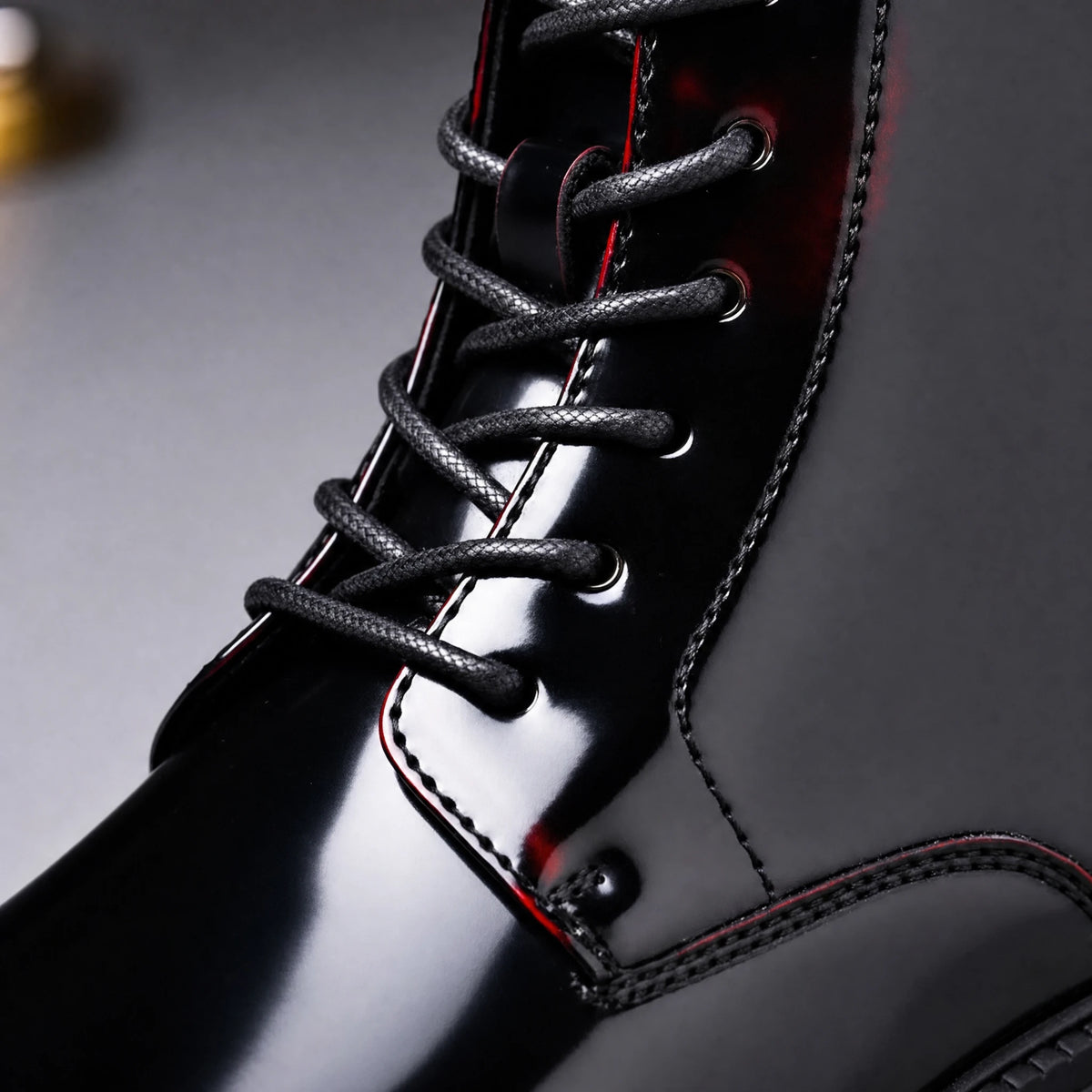 Lace-up front close-up on black cherry men's ankle boot