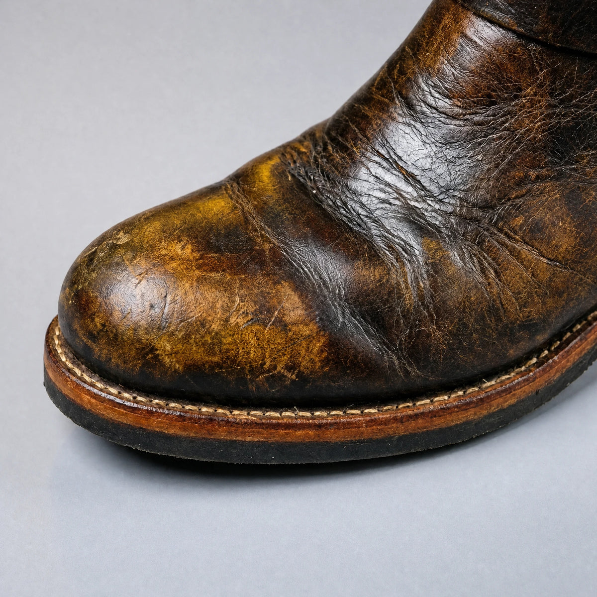 Rounded toe close-up on distressed vintage brown engineer boot