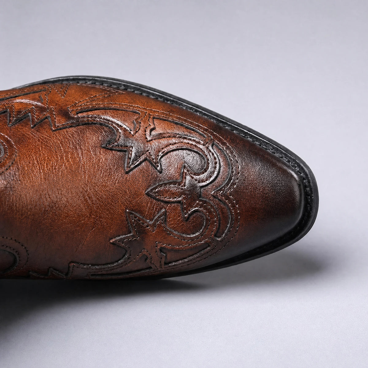 Pointed toe close-up with Western stitching on cognac brown boot