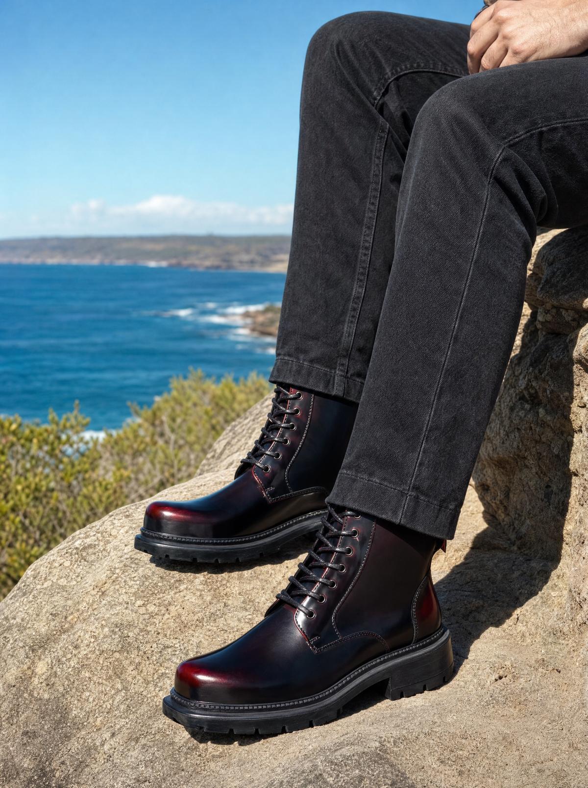Black cherry men's lace up boots with lug sole on a coastal walking track